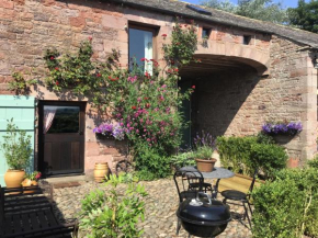 Historic converted byre in courtyard of 16C house